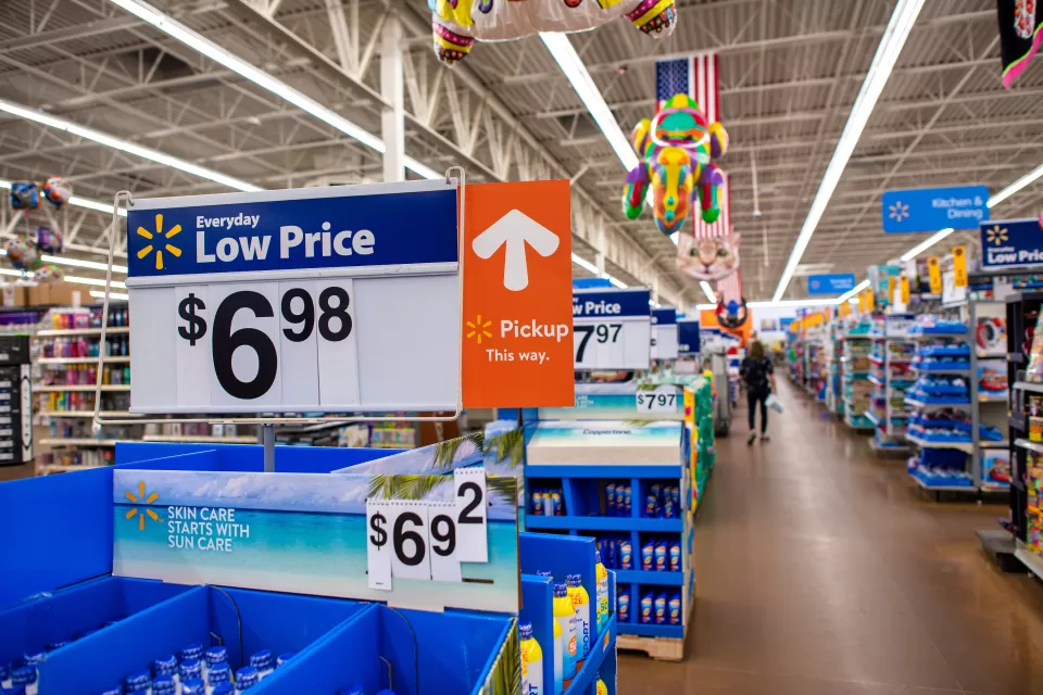 Interior of Walmart store with "Low Price $6.98" sign in foreground